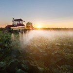 tractor spraying pesticides containing glyphosate